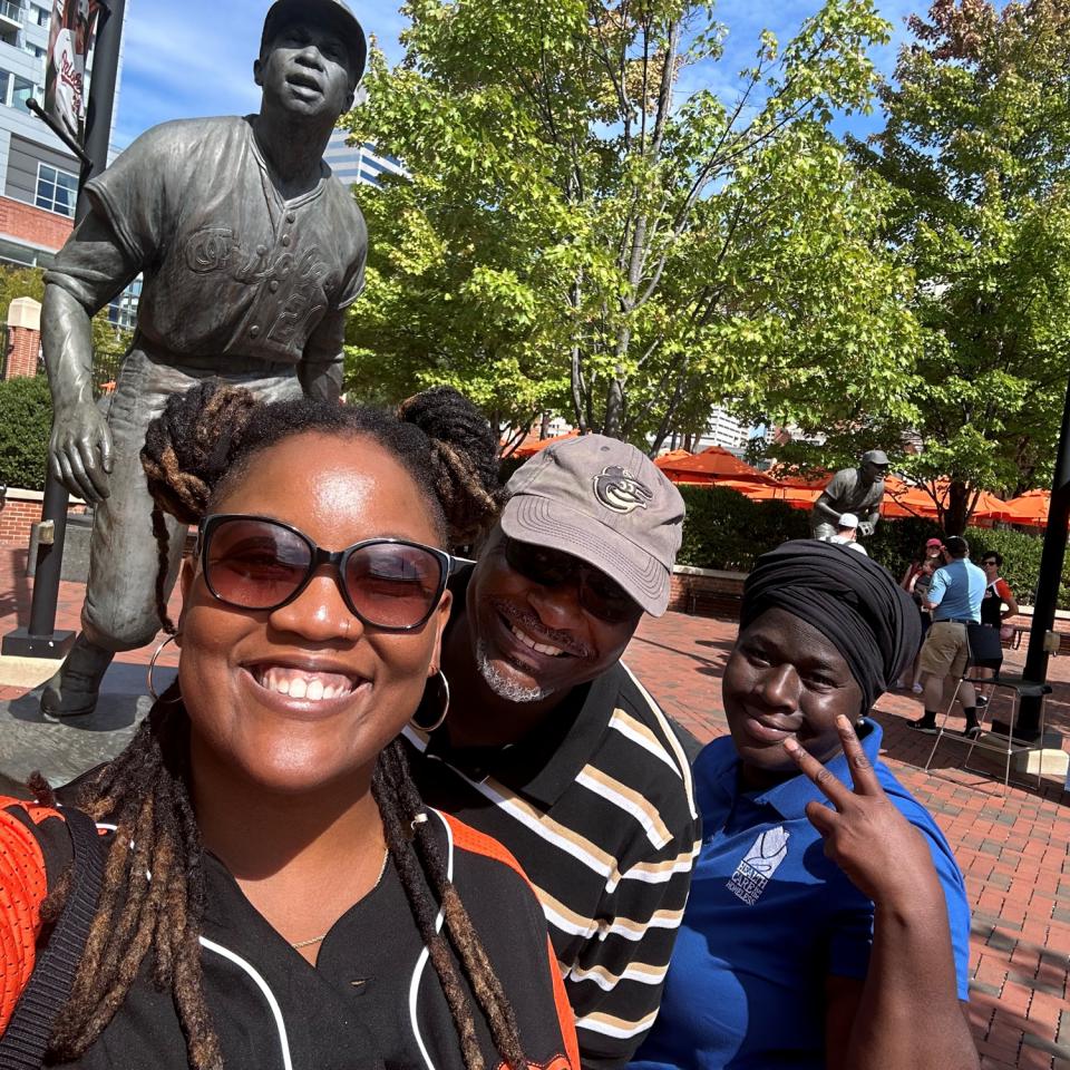 Three people smile for a selfie